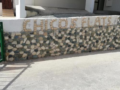a wall of rocks on the side of a building at Chicos Studios in Ayia Napa