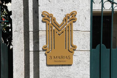 a sign for a marias sign on a wall at 3 Marias Residence in Viana do Castelo