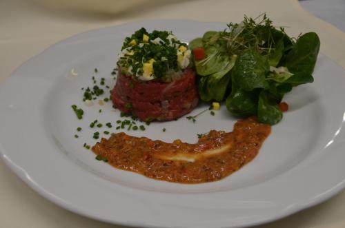 a plate of food with meat and vegetables on it at Castell Hotel & Restaurant in Leinsweiler