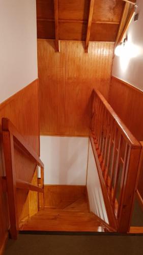 an overhead view of a wooden spiral staircase at Cabañas Rayen in Río Bueno