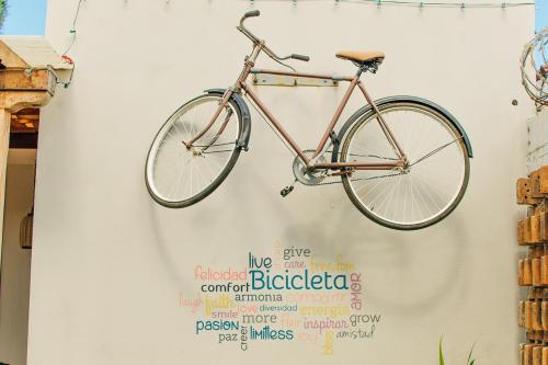a bike is hanging on a wall at La Bicicleta Hostal in Managua