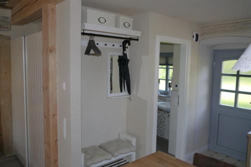 a room with a white wall with a window and a door at Ferienwohnung "Alte Bauernstube" in Meißen