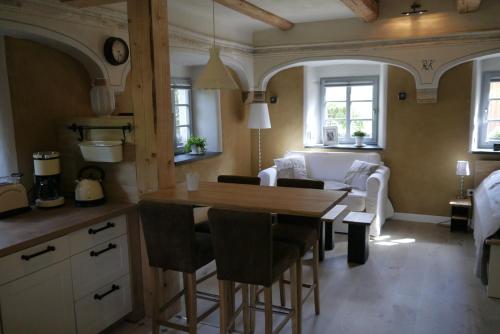 a kitchen and living room with a table and chairs at Ferienwohnung "Alte Bauernstube" in Meißen