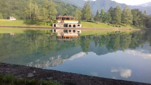 a reflection of a building in the water at Apartmani Košuta in Tjentište