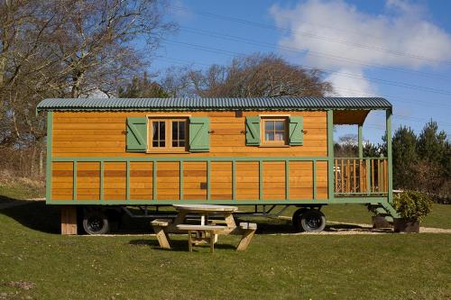 a tiny house sitting on top of a truck at The Hideaway Huts in Bardon Mill