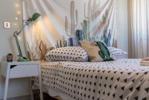 a bedroom with a bed with a cactus wall at Cramé House in Cortegaça