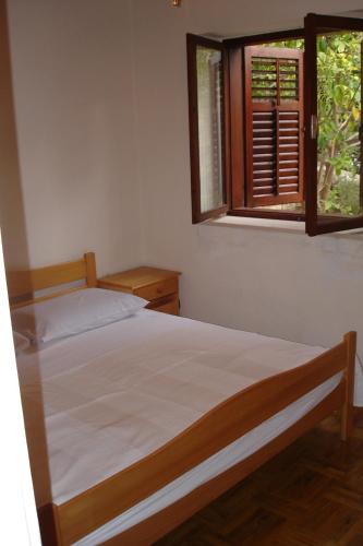 a bedroom with a bed and a window at Ancila in Brna