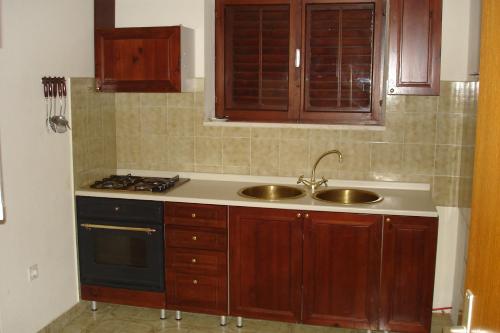 a kitchen with a sink and a stove at Ancila in Brna
