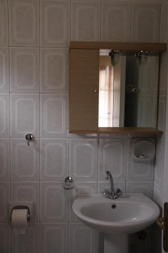 a bathroom with a sink and a medicine cabinet at Katerina Rooms in Syvota