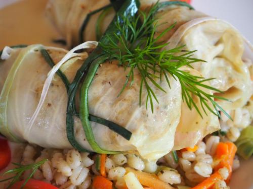 a plate of food with chicken on top of rice and vegetables at Hotel Spichlerz Lubawa in Lubawa