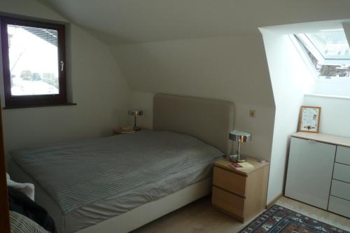 a small bedroom with a bed and a window at Villa Bellevue Apartment 1 Deluxe Apartment in Ossiach