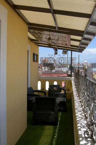 a balcony with chairs and tables on a building at Hotel Boutique Posada XVII in Puebla