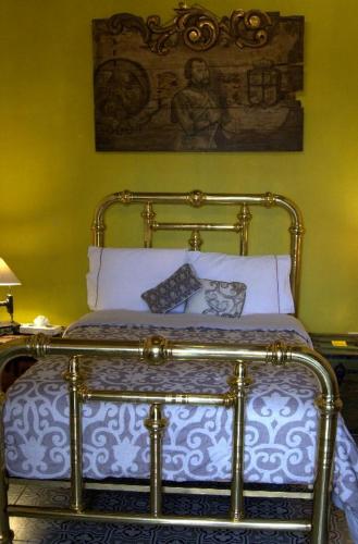 a bedroom with a bed with a blue and white comforter at Hotel Boutique Posada XVII in Puebla