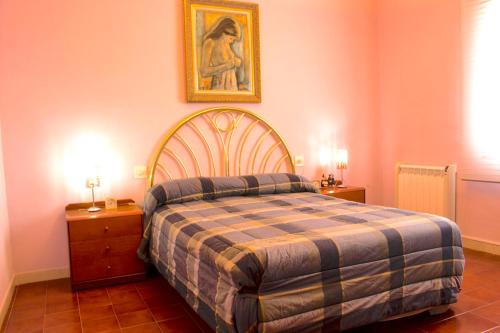 a bedroom with a bed and a picture on the wall at Artistic apartment with panoramic views in Canet de Mar