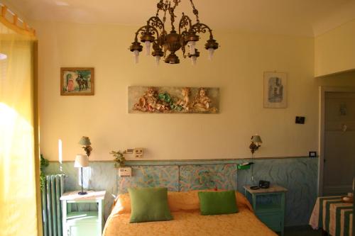 a bedroom with a bed and a chandelier at Villa Gaia in Taormina