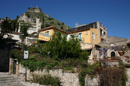 a group of buildings on the side of a hill at Villa Gaia in Taormina