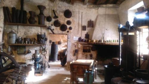 a room with a fireplace with pots and pans on the wall at Agriturismo Casa Mattei in Arrone