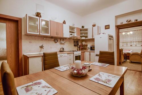 a kitchen with a wooden table with a candle on it at Pod Svatým kopečkem in Mikulov