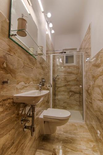 a bathroom with a toilet and a sink and a shower at Pod Svatým kopečkem in Mikulov