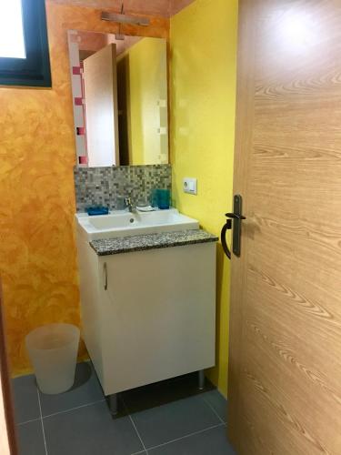 a bathroom with a sink and a mirror at Los Tres Soles in Silleda