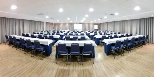 a large room with tables and chairs in it at Marante Executive Hotel in Recife