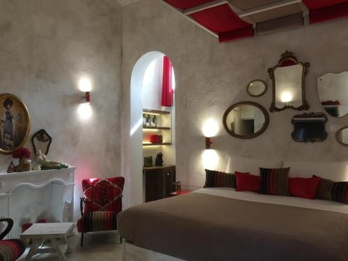 a bedroom with a bed and a window and mirrors at Il Pozzo di Santa Zita in Lucca