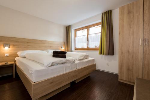 Ένα ή περισσότερα κρεβάτια σε δωμάτιο στο Apartments Alpenrose