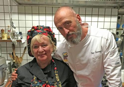 a man and a woman standing in a kitchen at Agriturismo Casa Mattei in Arrone