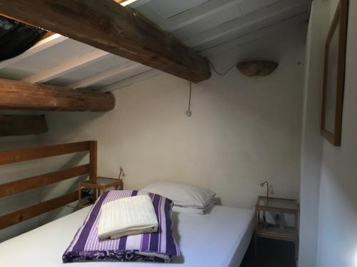a bedroom with a bed in a room with wooden ceilings at La Fratta Art - House in Marsciano
