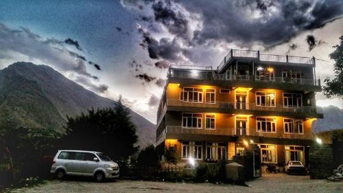 a building with a car parked in front of it at Hunza View Hotel in Hunza Valley