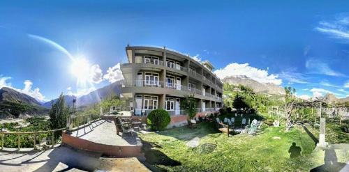 a large building with a playground in front of it at Hunza View Hotel in Hunza Valley