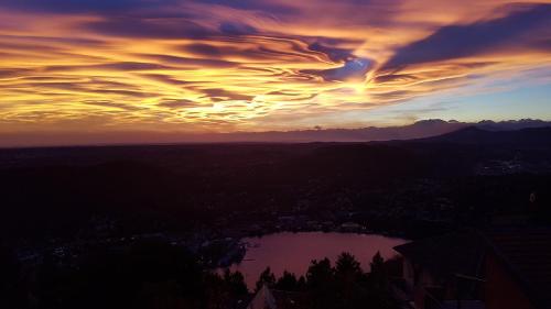 a sunset with a cloudy sky over a lake at Bellavista Boutique Hotel in Brunate
