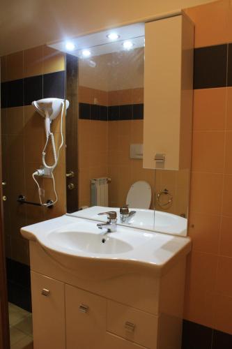 a bathroom with a white sink and a mirror at Smeraldo in Levanto