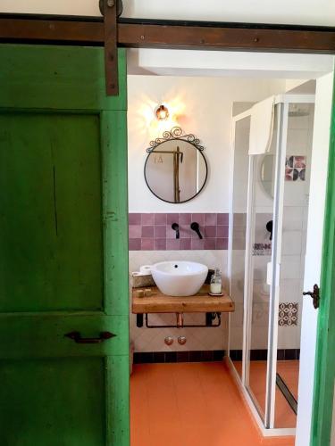 a bathroom with a sink and a mirror at La Goiaba B&B in Senigallia