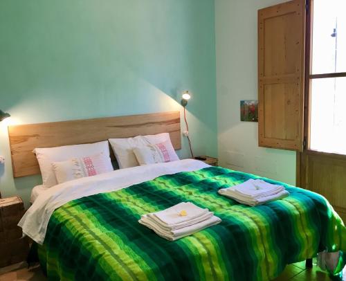 a bedroom with a bed with towels on it at La Goiaba B&B in Senigallia