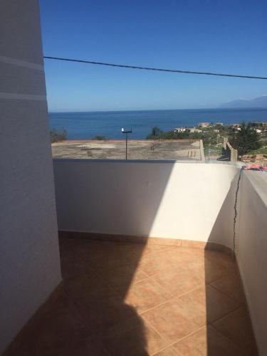 a room with a window with a view of the ocean at Mana Apartments in Ksamil