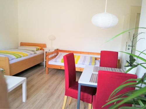 a bedroom with a bed and a table and chairs at Quiet City-Apt, 4min City-Center, 18min Fair Nürnberg!!! in Nürnberg