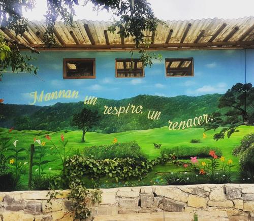 a mural on the side of a building at Cabañas Mannan in Tanchachín