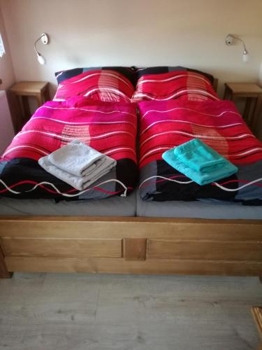 a bed with two pillows on top of it at Ubytovani na hradbach in Broumov