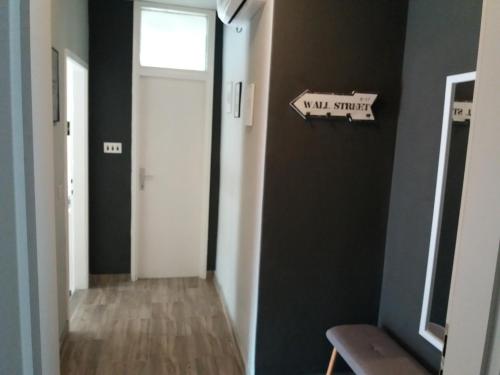 a hallway with a white door and a sign on a wall at Apartments Danijela in Tribunj
