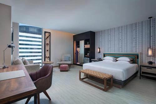 a bedroom with a bed and a desk and a couch at Hyatt Centric Guatemala City in Guatemala