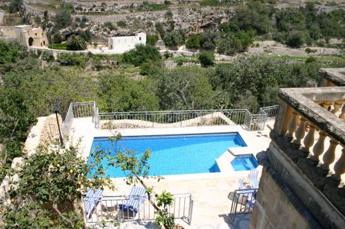a swimming pool in a villa with a view at Sylvia' s Millhouse in Kerċem