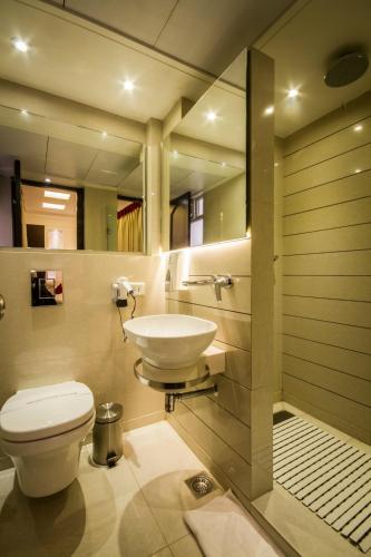 a bathroom with a toilet and a sink at Hotel Grand Godwin - Free Airport Pick-Up in New Delhi