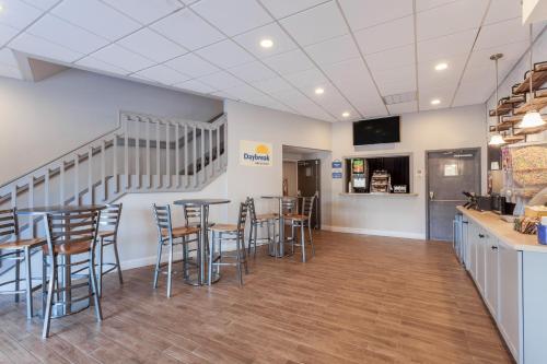 a restaurant with tables and chairs in a room at Days Inn & Suites by Wyndham Lancaster Amish Country in Lancaster