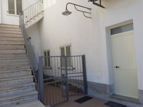 a white building with a staircase and a door at Home Sweet Home Galatro in Galatro