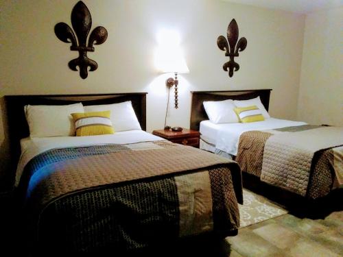 a hotel room with two beds and a lamp at Rothesay Motel in Rothesay