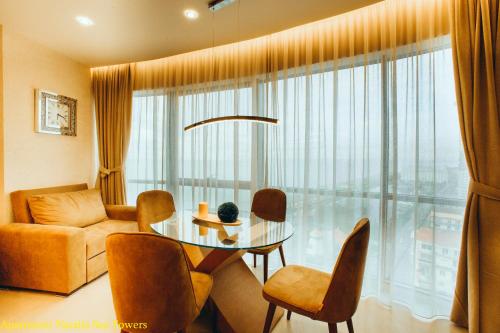 a living room with a table and chairs and a couch at Apartment Natalia Sea Towers in Batumi