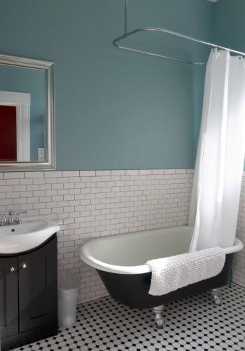 a bathroom with a bath tub and a sink at Sauerdough Lodging in Seward