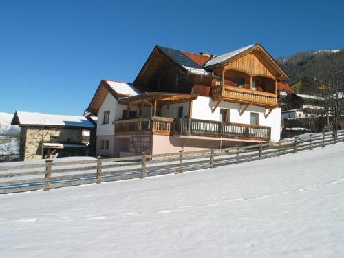 a house with a fence in the snow at Ferienhaus Sternhof in Mieders