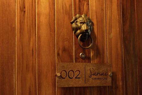 a door with a horse head knocker on it at Sanae' Townhouse Chiang Mai in Chiang Mai